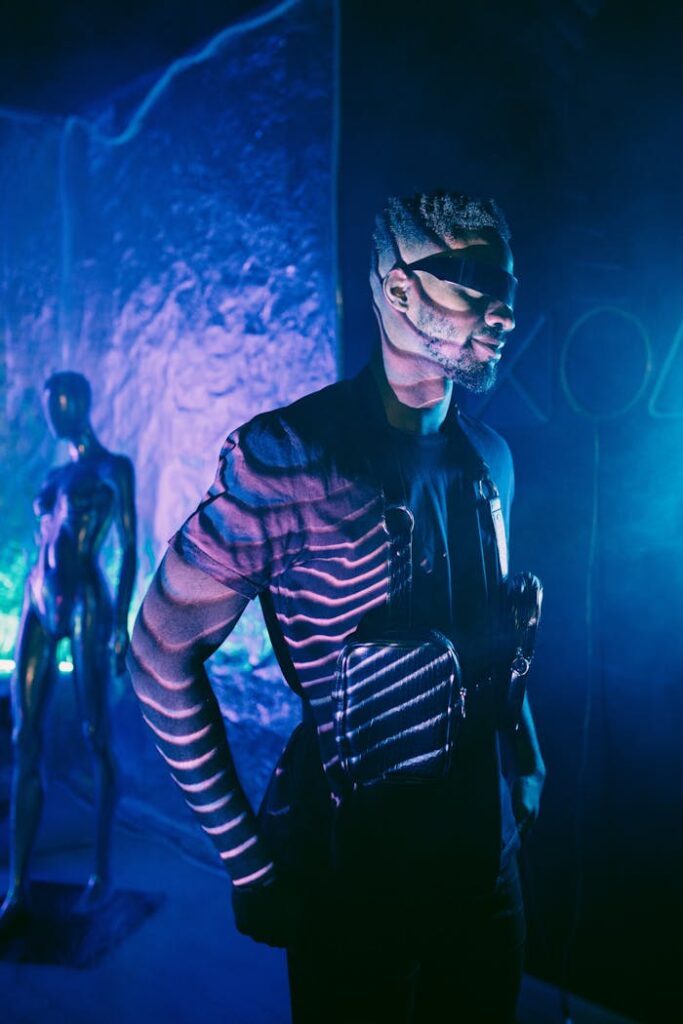 A stylish adult wearing sunglasses in neon lights, evoking a cyberpunk atmosphere.